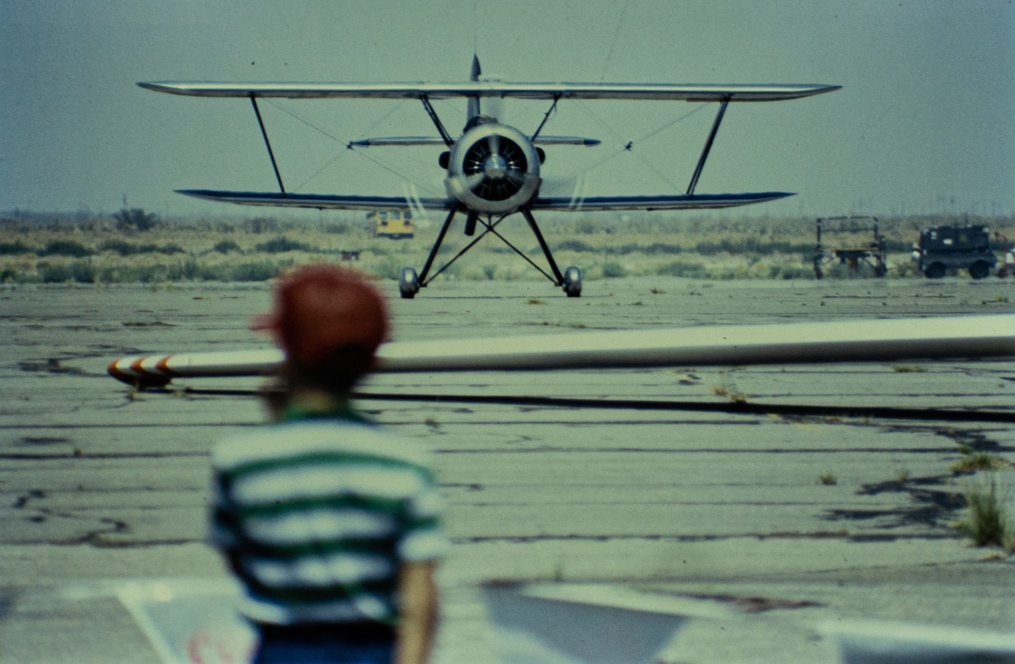 Kid watching biplane.jpg