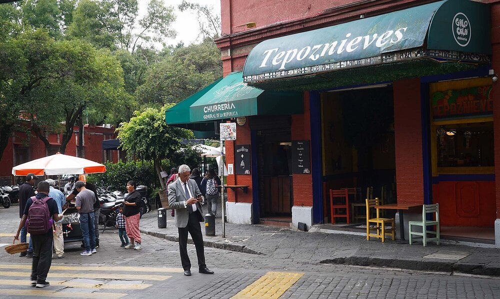 Man in sport coat in front of Tepoznieves Restaurant in Mexico City
