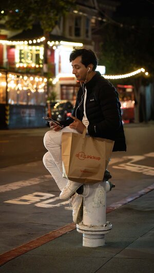 Man sitting on fire plug (1 of 1).jpg