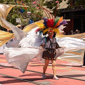 San Francisco Pride Parade 2026 - Man with flowing White cloth and feather headgear.