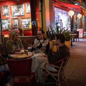 Two Couples Talking and sipping wine outside of Redstaurant