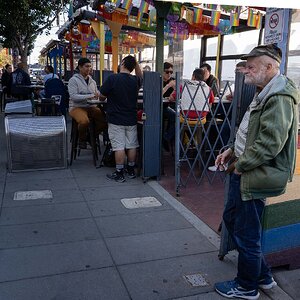 Old man outside restaurant