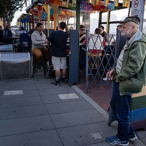 Old man outside restaurant