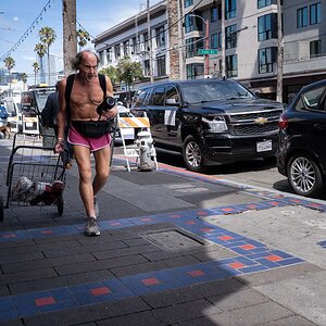 Angry man in shorts marching down Mission Street