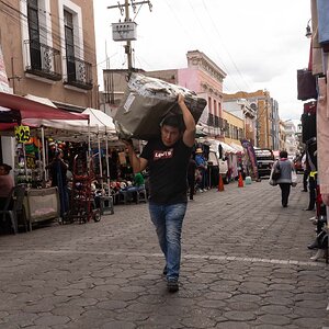 Man Carrying package on the street in Puebla City