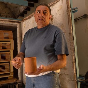 Pottery factory With boss explaining firing