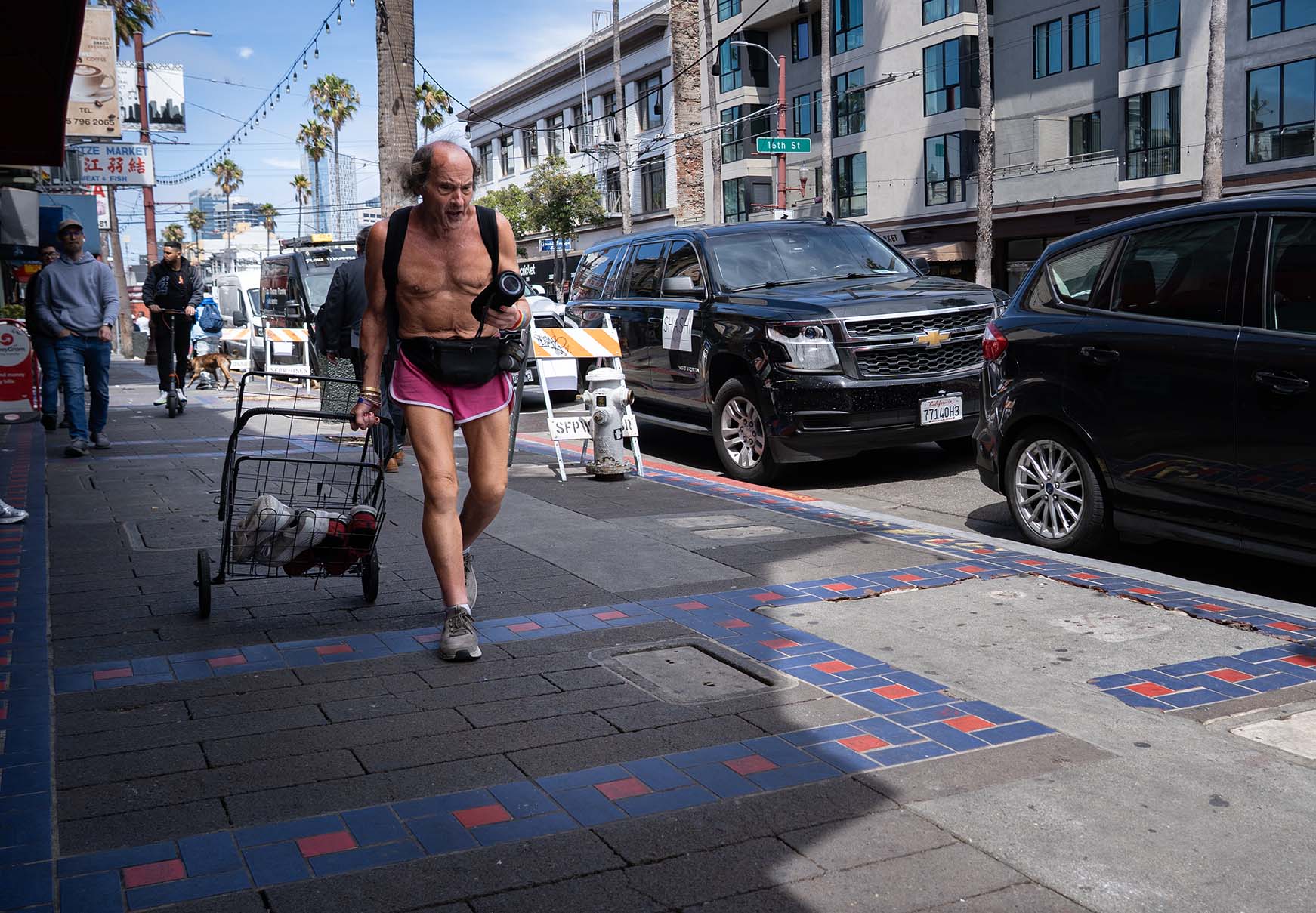 Angry man in shorts marching down Mission Street