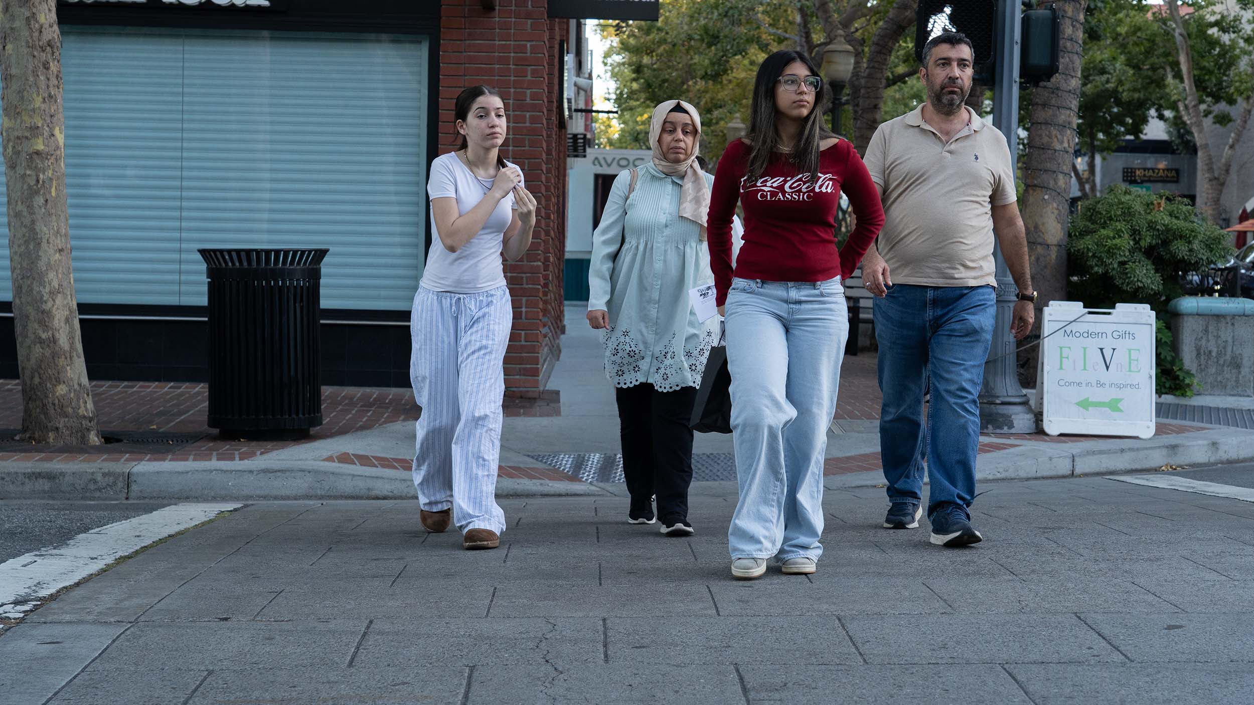 Family walking down University Ave in Palo Alto, California