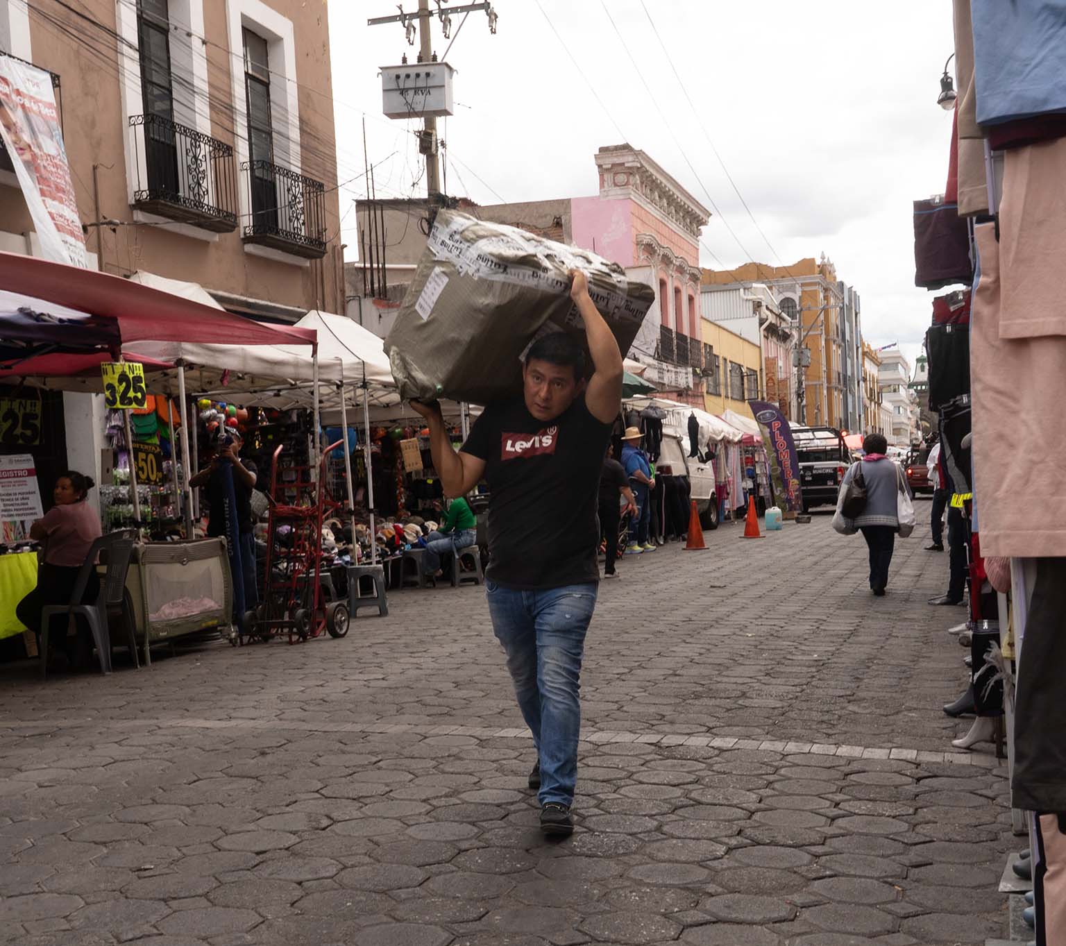 Man Carrying package on the street in Puebla City
