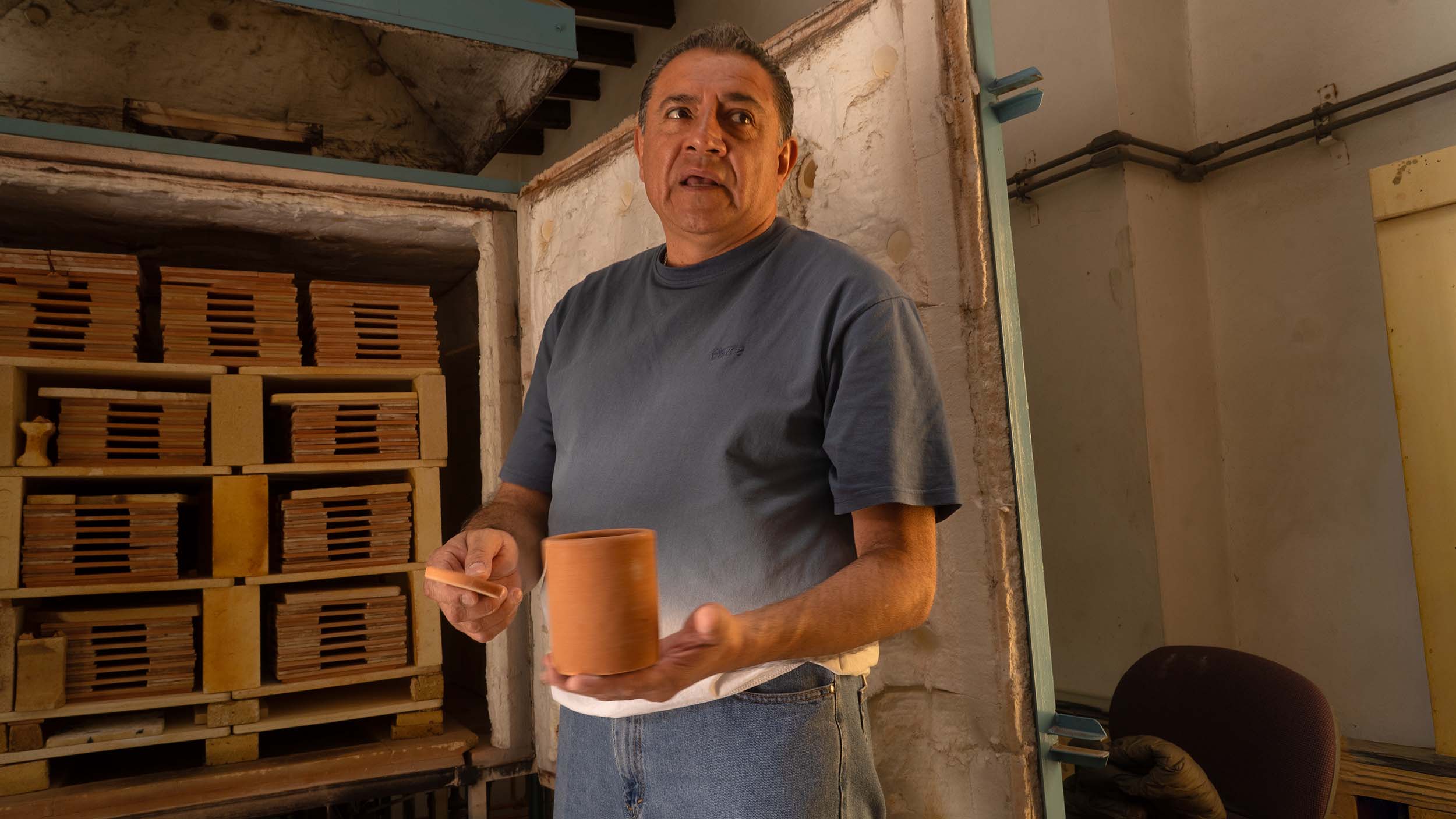 Pottery factory With boss explaining firing