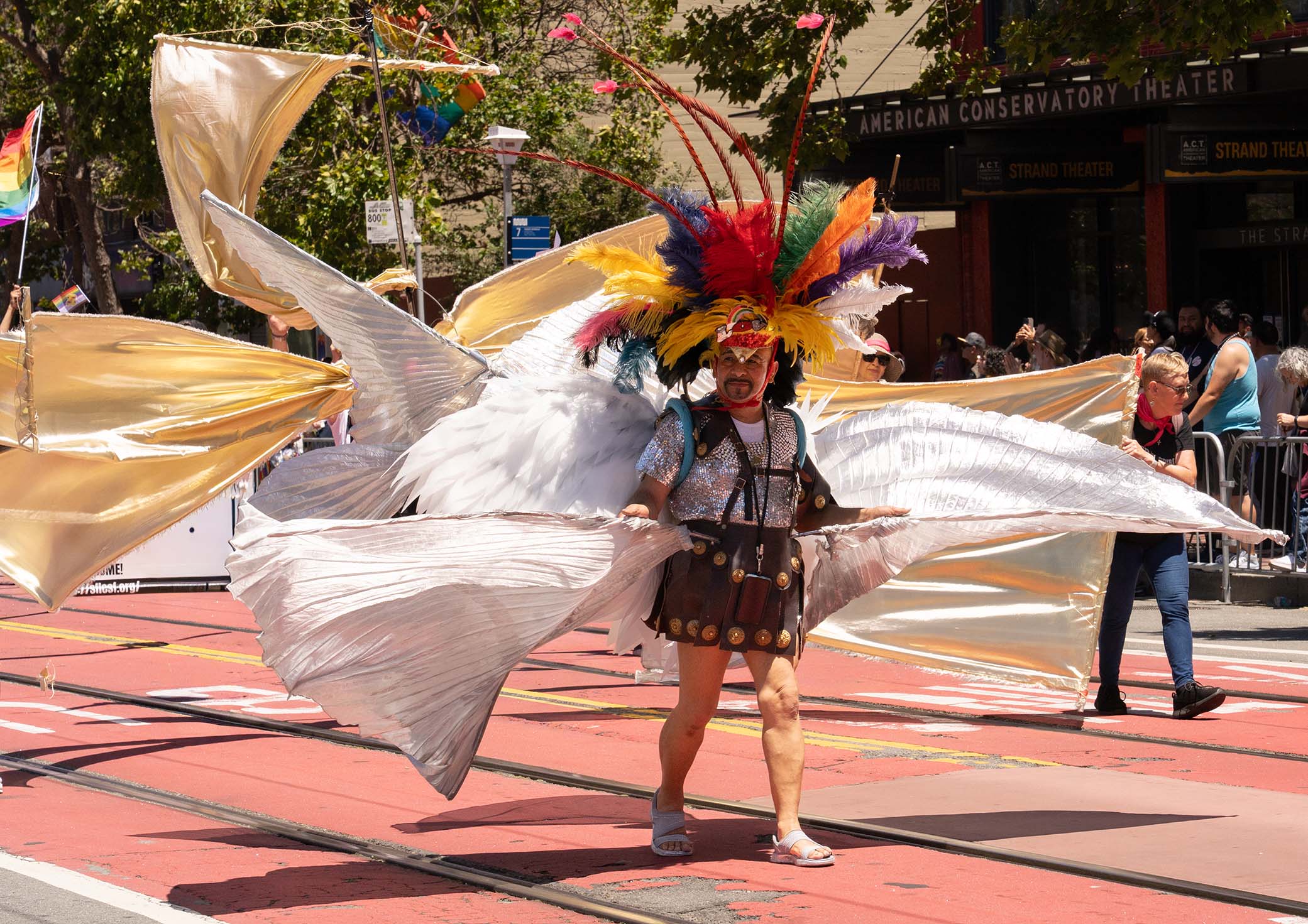 San Francisco Pride Parade 2026 - Man with flowing White cloth and feather headgear.