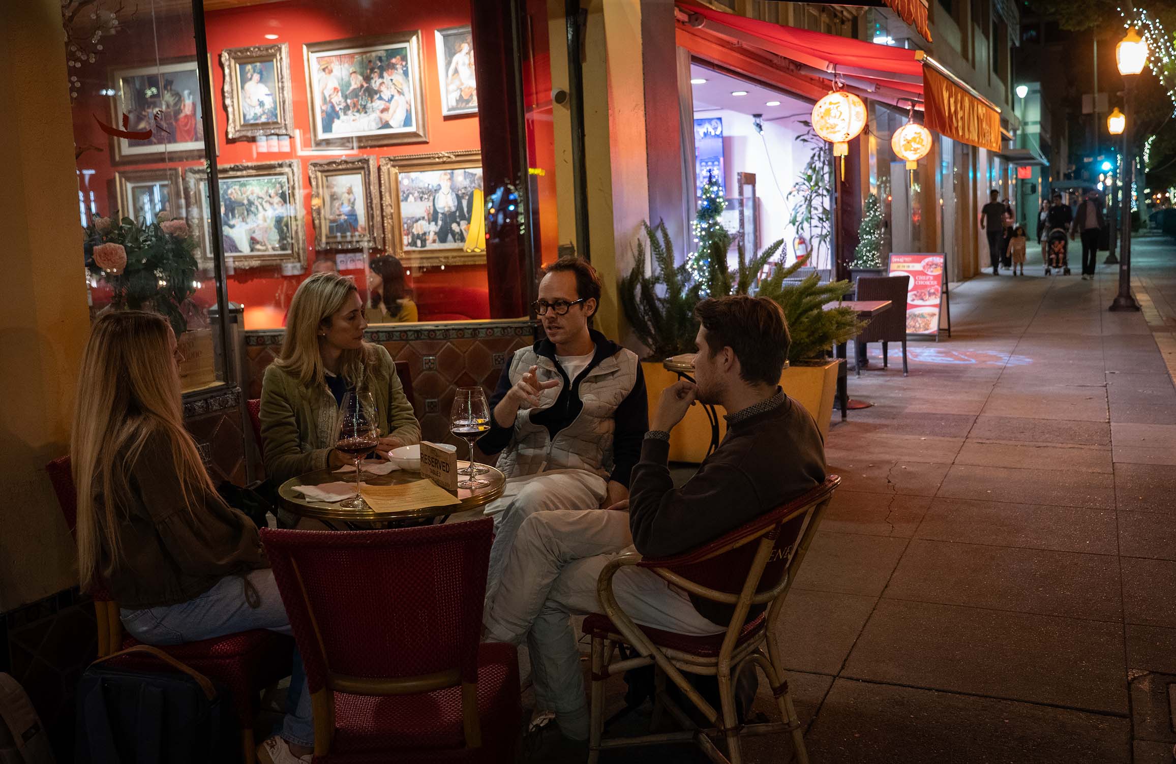 Two Couples Talking and sipping wine outside of Redstaurant
